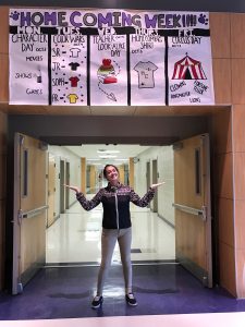 Senior Abbie Purugganan stands in front of her sign advertising Homecoming Week on September 26, 2016.