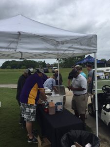 Jay Ducote serves food to Woodlawn supporters at Football Golf Tournament on April 18, 2016.