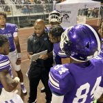Offensive coordinator Tramon Douglas talks to his receivers and quarterbacks