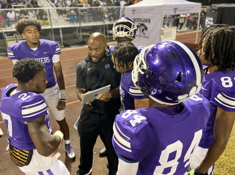 Offensive coordinator Tramon Douglas talks to his receivers and quarterbacks